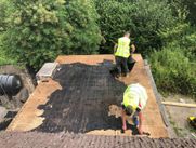Men working on a flat roof in Galway